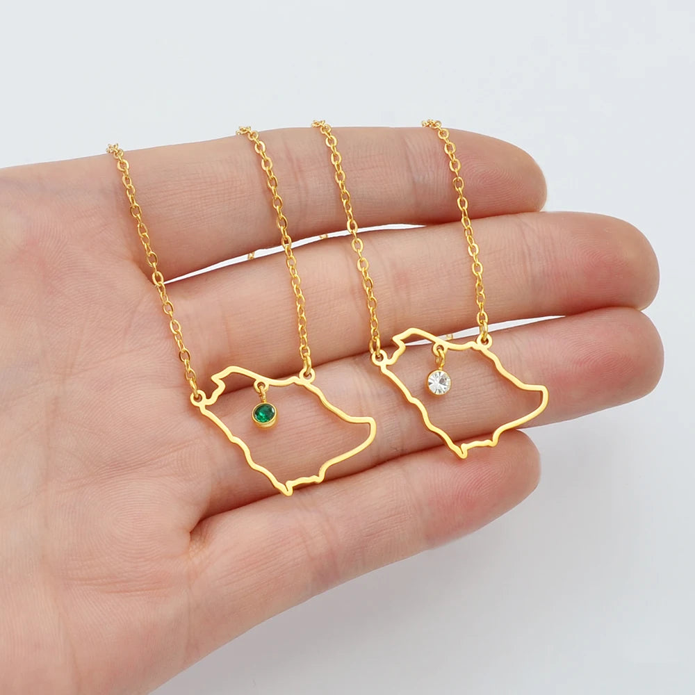 Two gold Saudi Arabia map necklaces with gemstones.