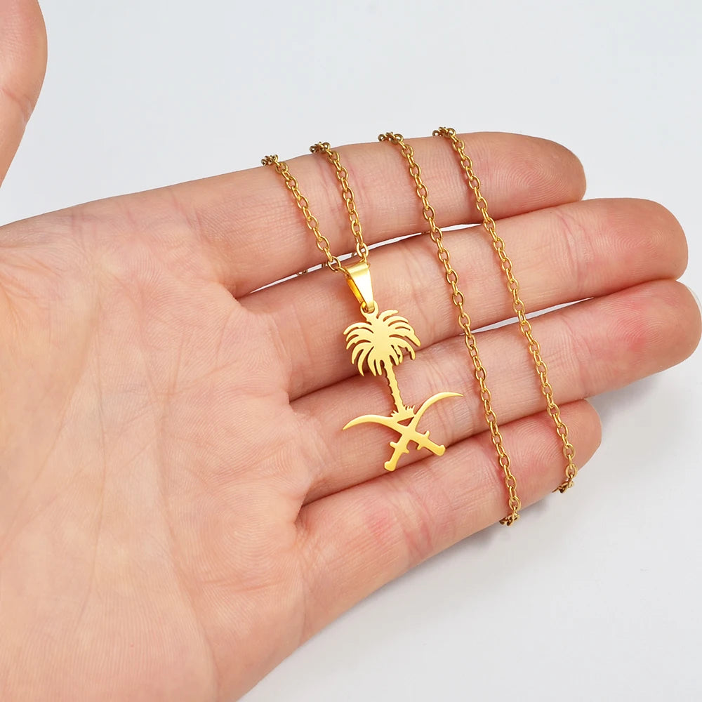 Gold Saudi Arabia emblem necklace on a hand.